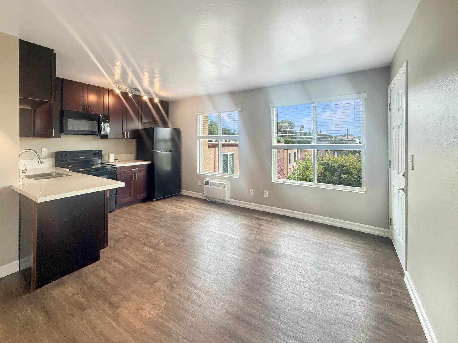 Renovated kitchen with quartz counters and refreshed cabinetry